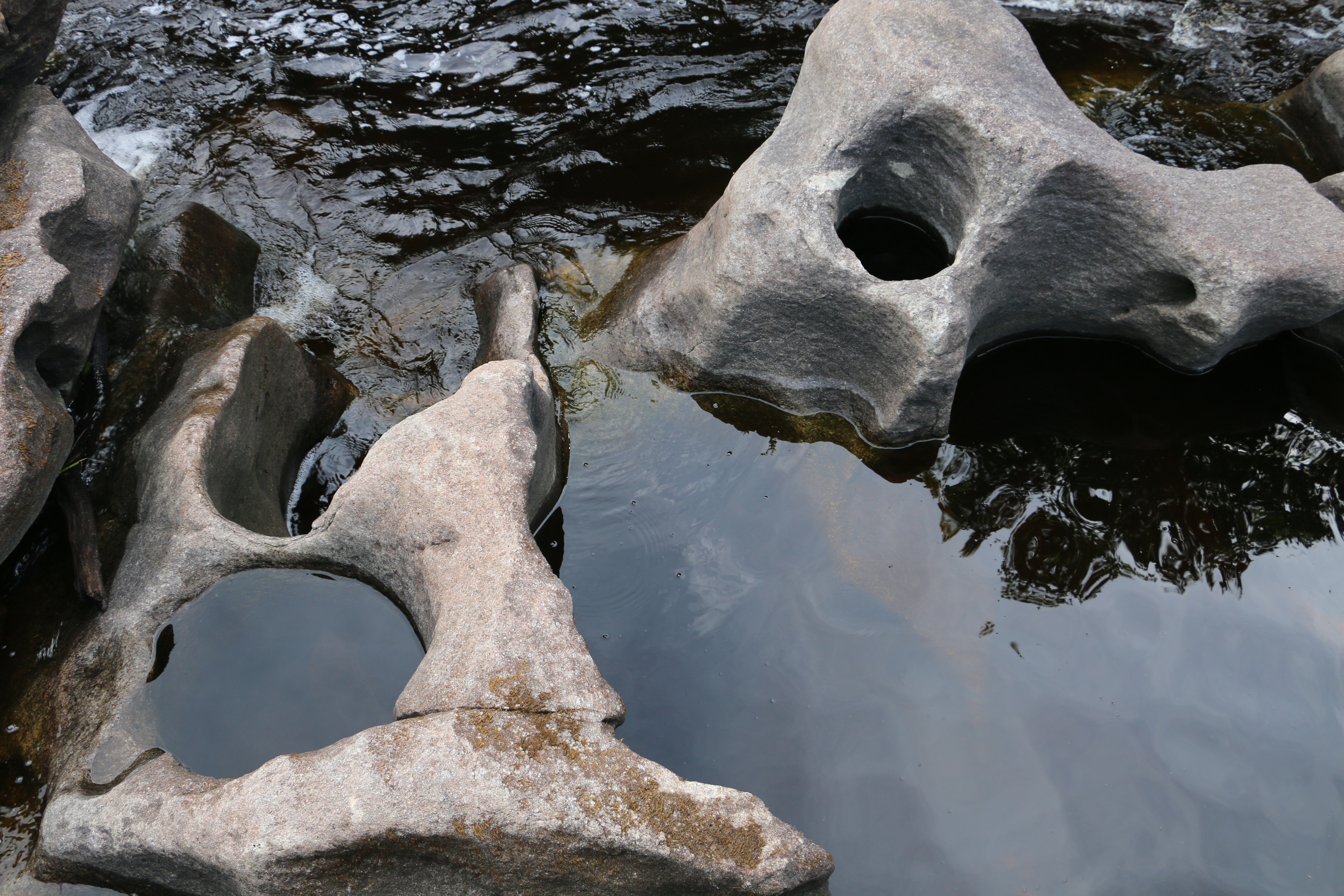 A formation of rocks with natural holes carved in from water erosion