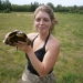 SUNY Potsdam student Rebecca Cruz with a Blanding’s turtle captured after nesting in the field behind her. Photo: Jonathan Ashley. Blanding’s turtle captured after nesting in field.